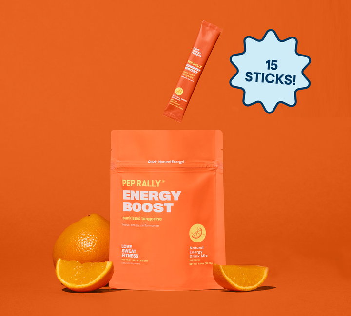 A package of Pep Rally Energy Boost with 15 sticks, displayed alongside slices of tangerine against an orange background.