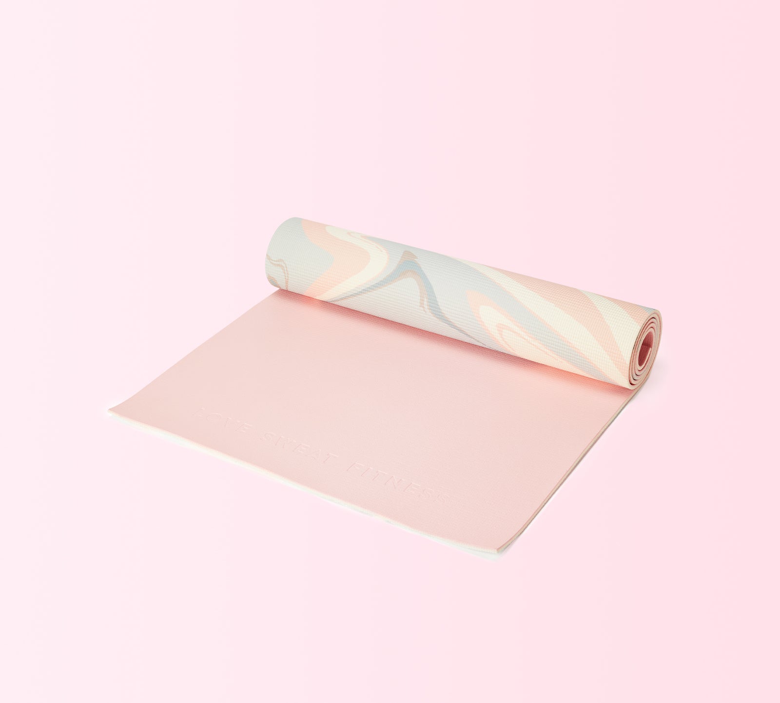 A rolled out pink yoga mat with a textured surface, partially unrolled to reveal a shiny, reflective end.