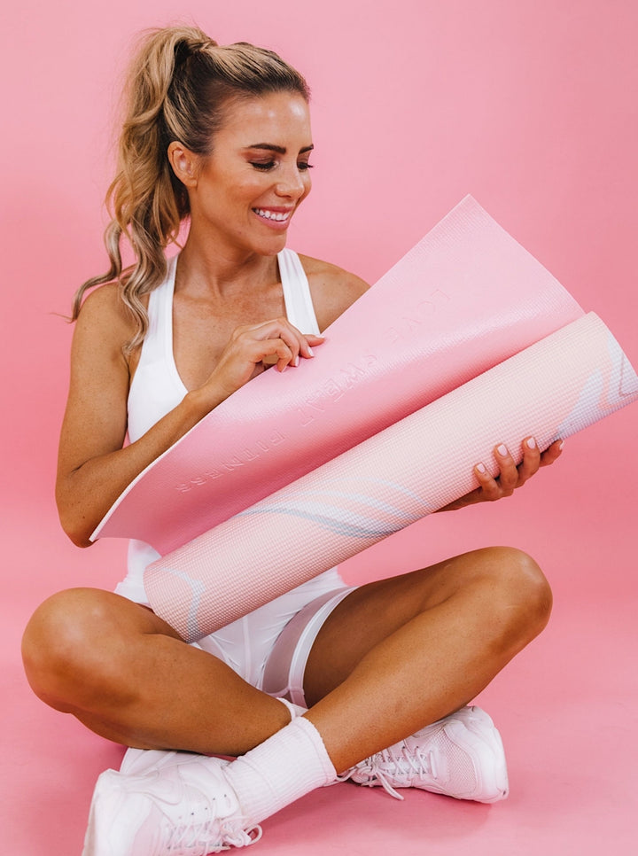 Girl with pink yoga mat