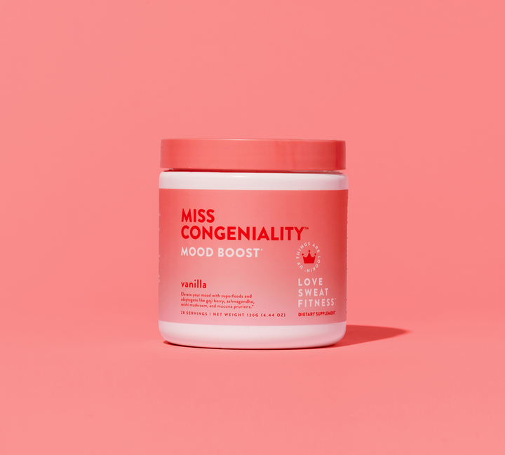 A pink container of Miss Congeniality mood-boosting vanilla blend on a pink background.