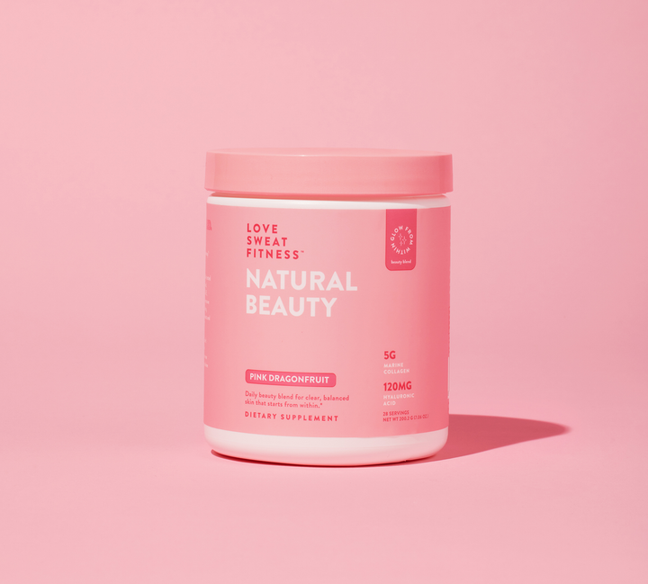 A pink container labeled 'LOVE SWEAT FITNESS NATURAL BEAUTY' with text indicating it is a skincare supplement, pink dragonfruit flavor, with 15g of collagen per serving.